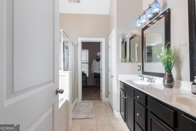 bathroom with tile patterned floors, a shower with shower door, and vanity