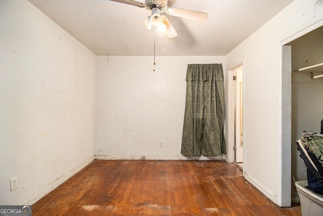 unfurnished bedroom with ceiling fan and dark hardwood / wood-style floors