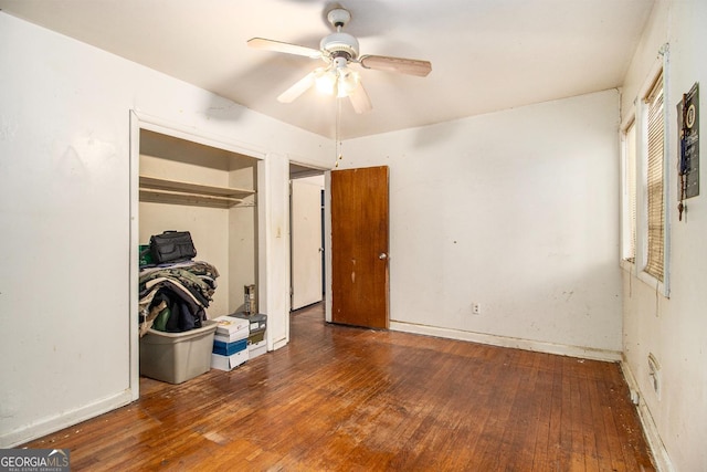 bedroom featuring dark wood-type flooring, ceiling fan, and a closet