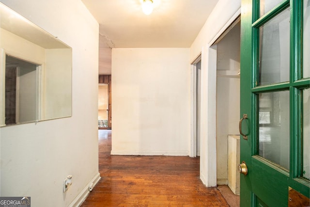 hall with dark wood-type flooring