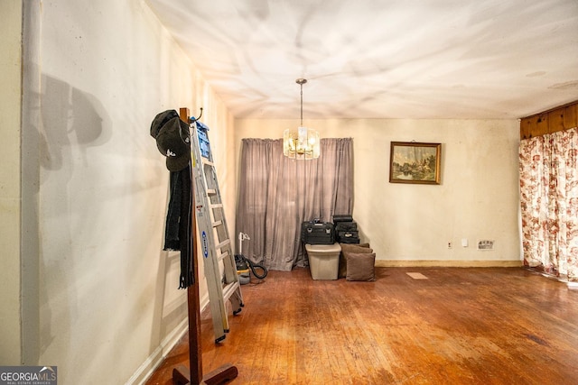 miscellaneous room featuring a notable chandelier and hardwood / wood-style flooring