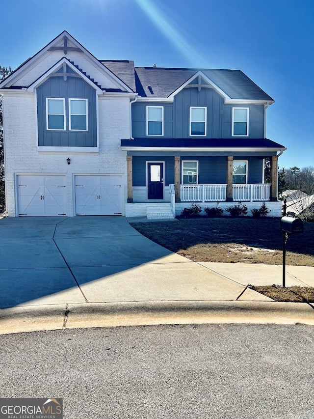 view of front of property with a porch and a garage