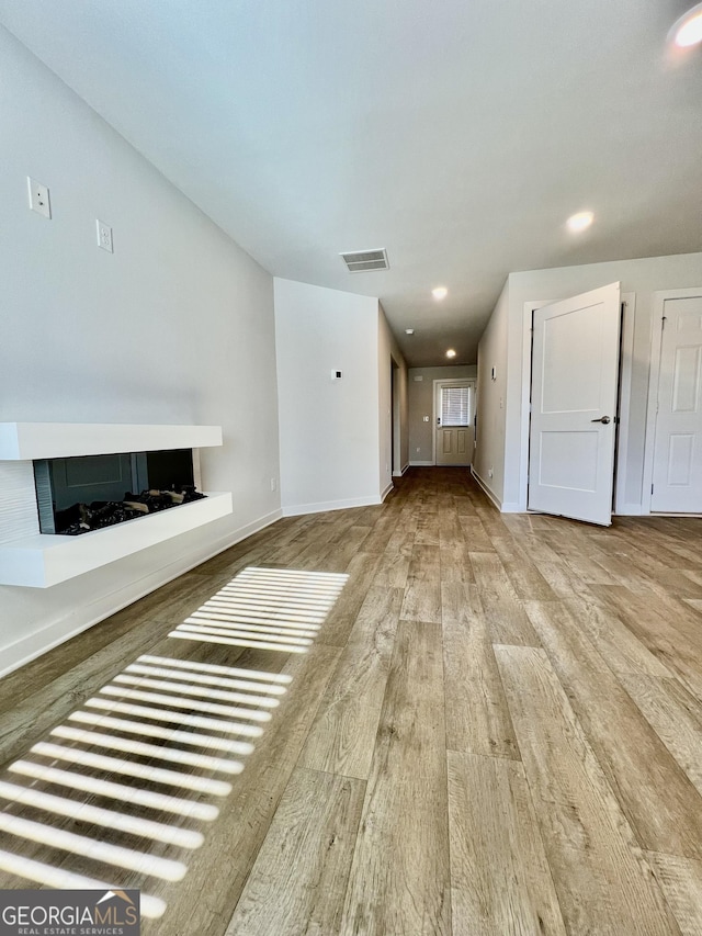 unfurnished living room with light hardwood / wood-style flooring