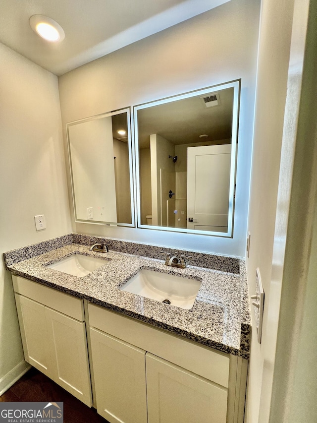 bathroom featuring vanity and a shower