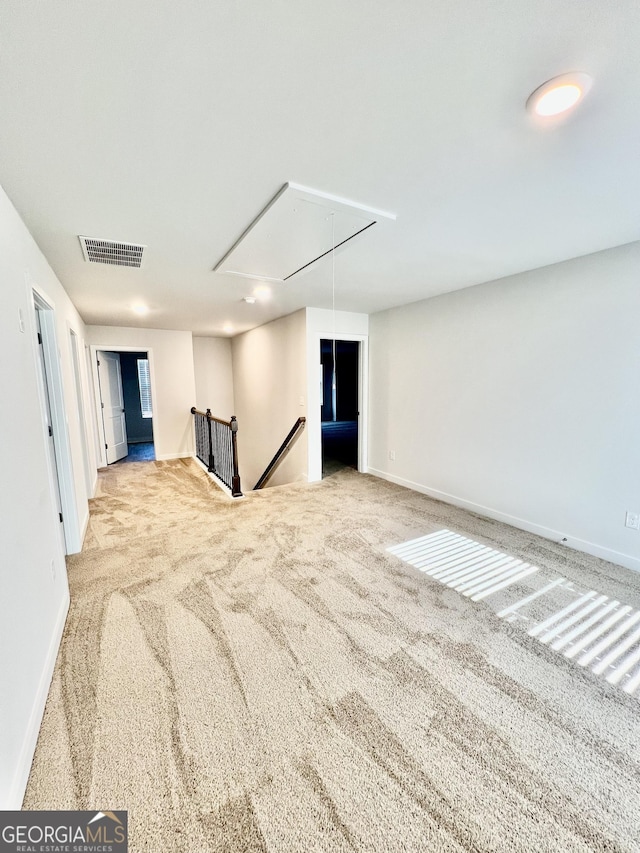 unfurnished room featuring light colored carpet