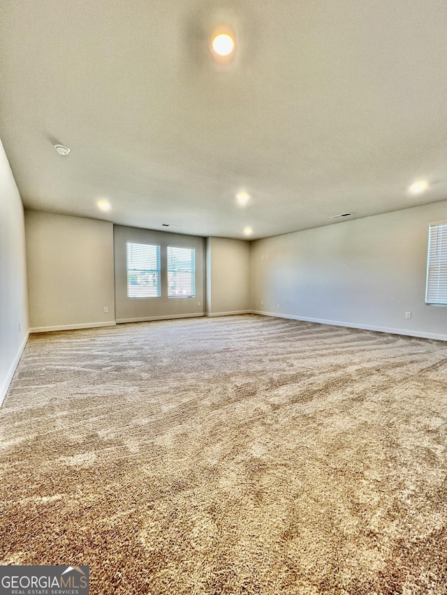 carpeted empty room with a textured ceiling