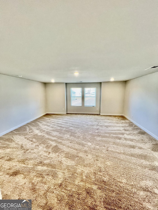 unfurnished room featuring carpet flooring and a textured ceiling