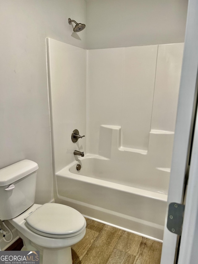 bathroom featuring toilet, shower / tub combination, and wood-type flooring