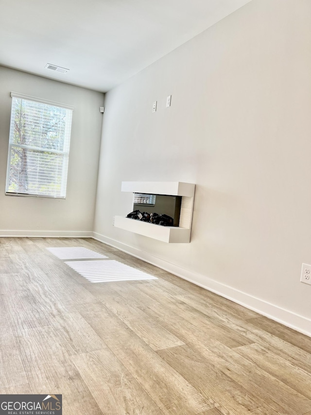 unfurnished living room with light wood-type flooring