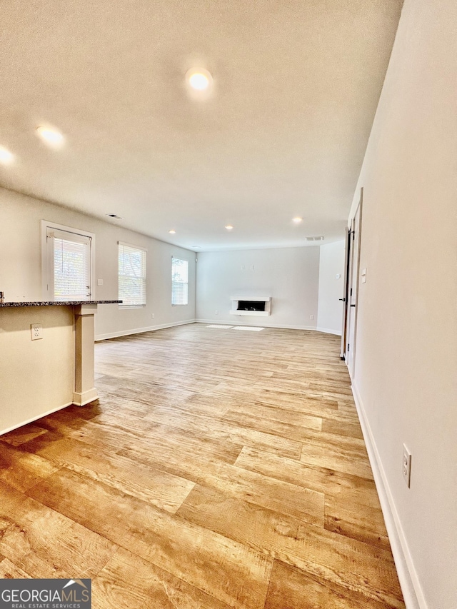 unfurnished living room featuring hardwood / wood-style floors