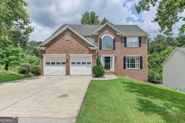 view of front of home with a front yard and a garage