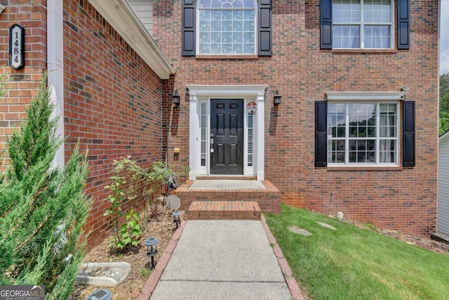 entrance to property featuring a yard