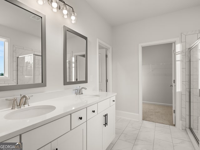 bathroom featuring vanity and a shower with door