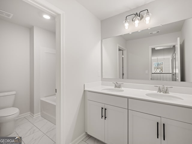 bathroom featuring vanity, toilet, and a bathing tub