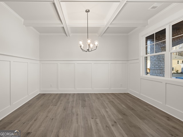 unfurnished dining area with coffered ceiling, crown molding, a chandelier, beam ceiling, and hardwood / wood-style floors