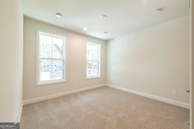 unfurnished room with light carpet