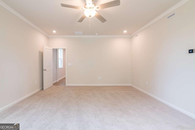 carpeted empty room featuring ceiling fan and ornamental molding