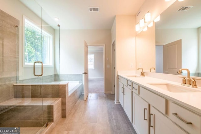 bathroom with vanity, independent shower and bath, and tile patterned flooring