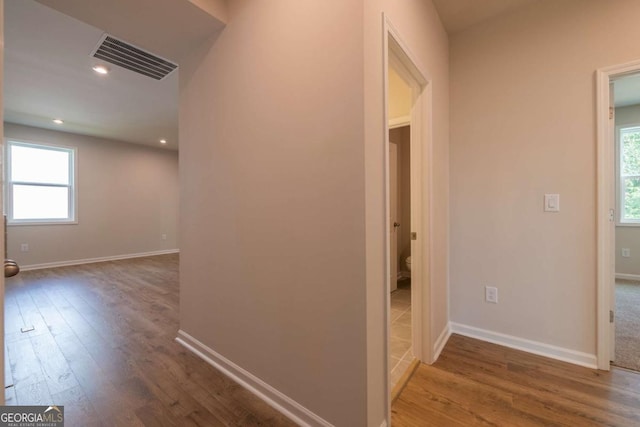 hallway with wood-type flooring