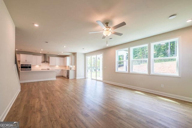 unfurnished living room with light hardwood / wood-style floors and ceiling fan