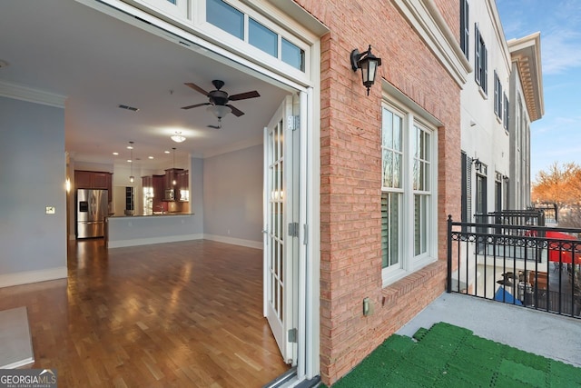 entrance to property with ceiling fan