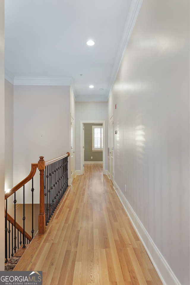 hallway with ornamental molding and hardwood / wood-style floors