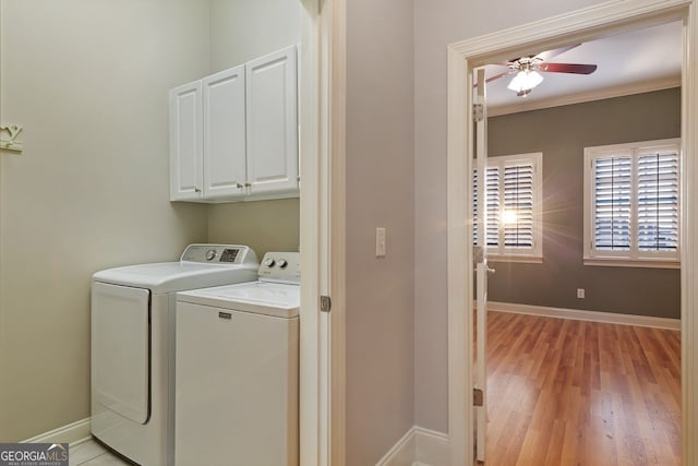 washroom featuring washer and dryer, cabinets, ceiling fan, crown molding, and light hardwood / wood-style flooring