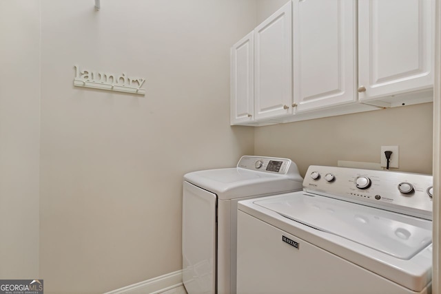 laundry room with cabinets and washing machine and dryer