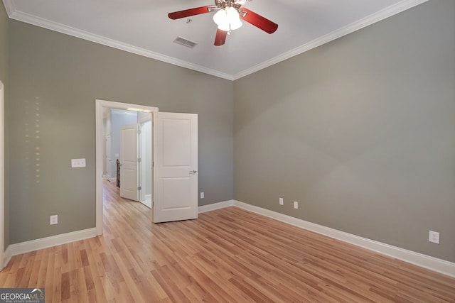 unfurnished room with ornamental molding, ceiling fan, and light wood-type flooring