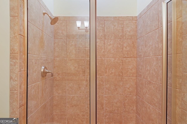 interior details featuring a tile shower