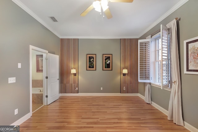 unfurnished bedroom featuring connected bathroom, ornamental molding, light hardwood / wood-style floors, and ceiling fan