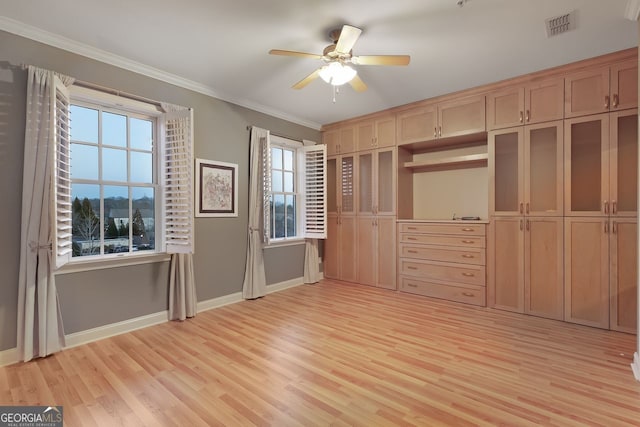 unfurnished bedroom featuring ornamental molding, ceiling fan, and light wood-type flooring