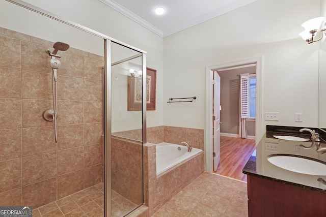 bathroom featuring vanity, tile patterned flooring, ornamental molding, and separate shower and tub