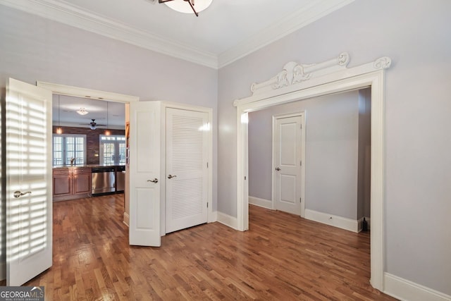 interior space featuring crown molding, sink, and hardwood / wood-style flooring