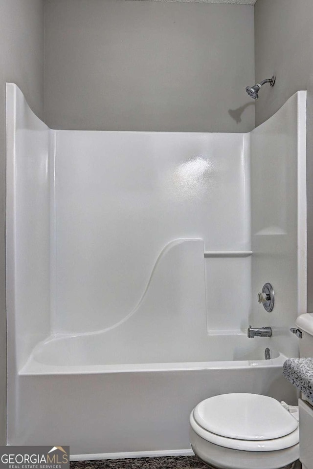 bathroom featuring  shower combination and toilet