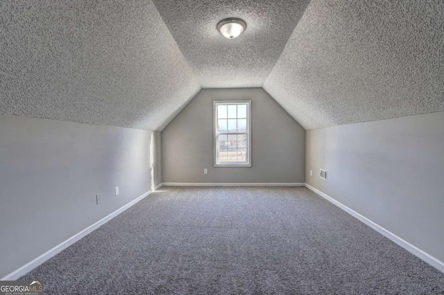 additional living space featuring carpet and lofted ceiling