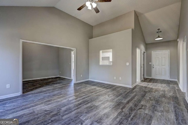 interior space with dark hardwood / wood-style floors, high vaulted ceiling, and ceiling fan