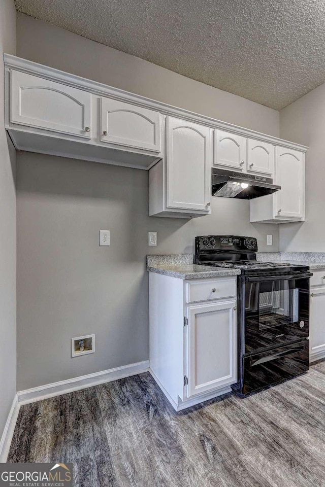 kitchen with dark wood-type flooring, white cabinetry, black / electric stove, and a textured ceiling