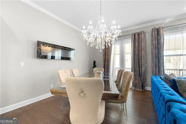 dining room featuring dark hardwood / wood-style flooring, ornamental molding, and an inviting chandelier