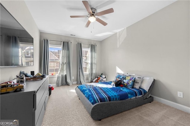 bedroom with ceiling fan and light carpet