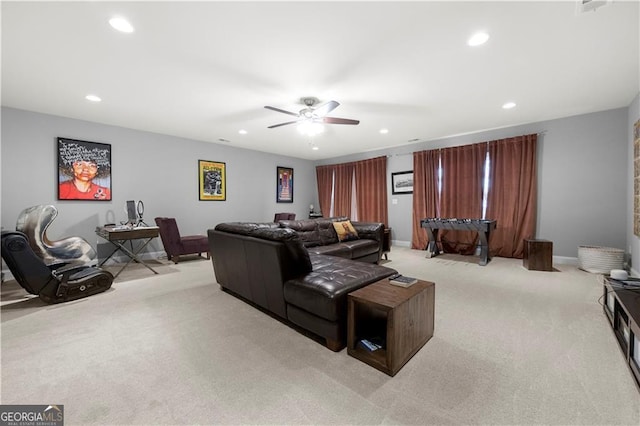 cinema room featuring ceiling fan and light carpet