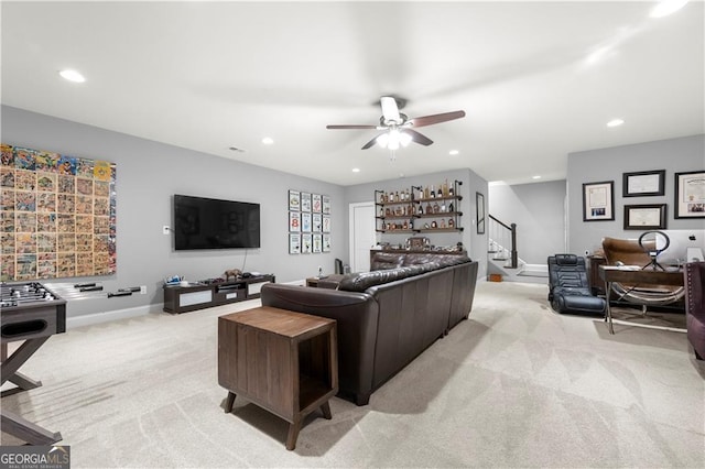 living room featuring light colored carpet and ceiling fan