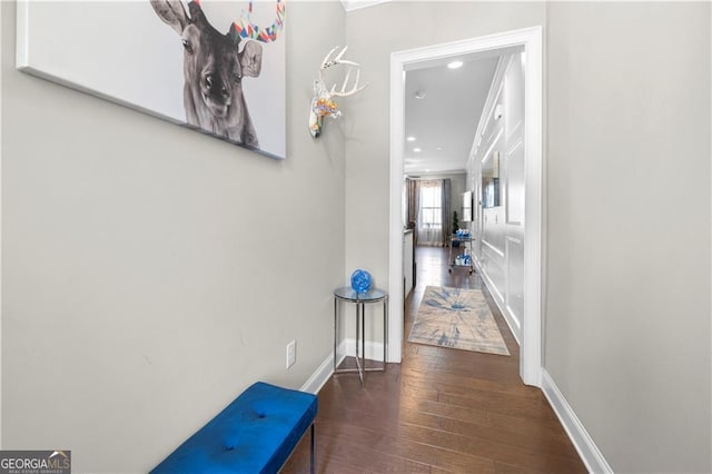 hallway featuring dark hardwood / wood-style floors and ornamental molding