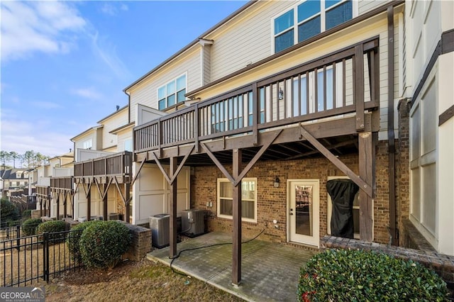 rear view of property featuring a patio area and central AC