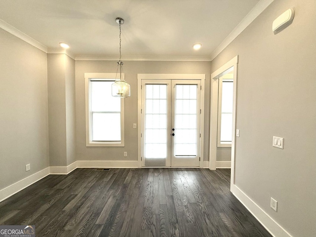 doorway with ornamental molding, plenty of natural light, dark hardwood / wood-style floors, and french doors