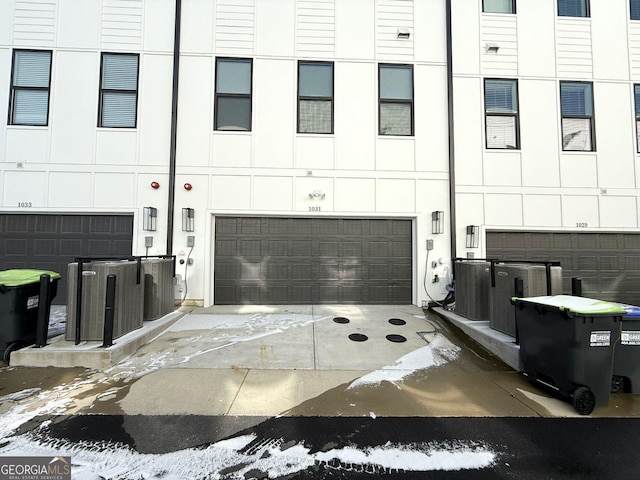 exterior space with a garage and central air condition unit