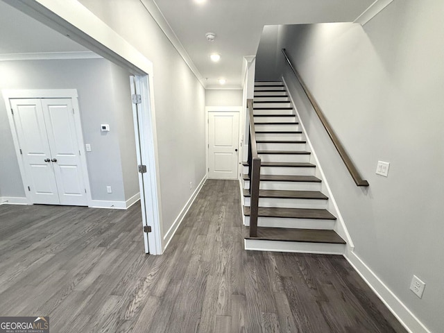 staircase featuring ornamental molding and hardwood / wood-style floors