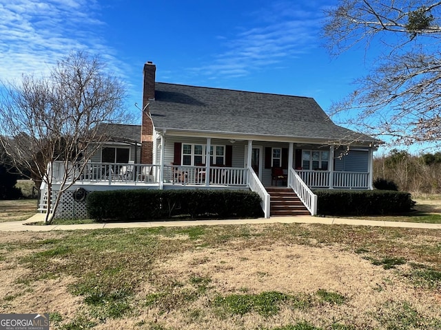 view of front of house featuring covered porch and a front yard