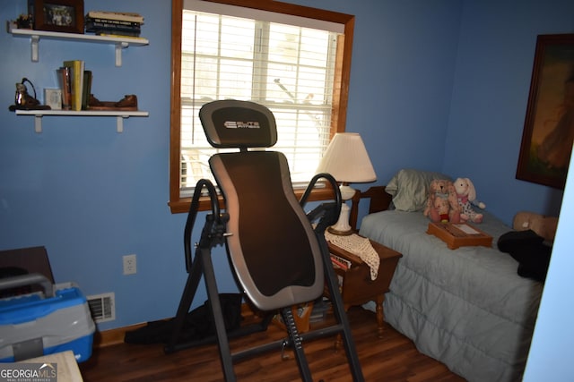 bedroom featuring dark hardwood / wood-style floors and multiple windows