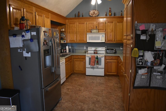 kitchen featuring vaulted ceiling and white appliances